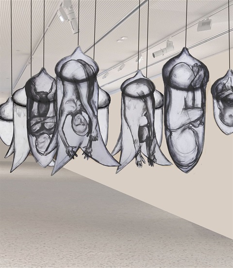 Image of artwork hanging from the ceiling in an art gallery.