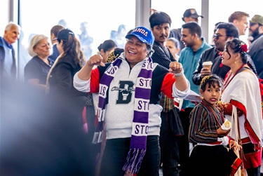 A woman in crowd cheering for her team 
