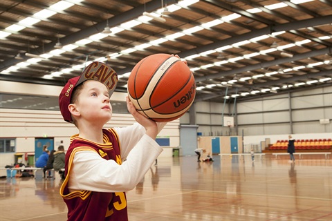 Boy gets ready to shoot a basketball hoop
