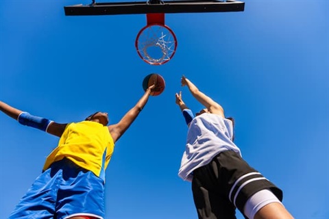 Two women basketball players training at city basketball court