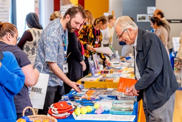 Community members engaging with the Information Stalls