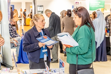 Community members engaging with the Information Stalls