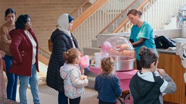 Kids and parents lining up to receive cotton candy