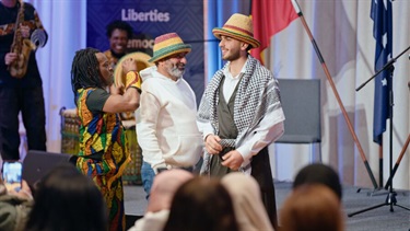Men on the stage showcasing their traditional attire 