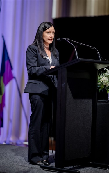 Mayor delivering speech on stage