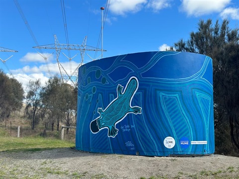 A CFA water tank with a mural painted on it depicting a Platypus by John Patten